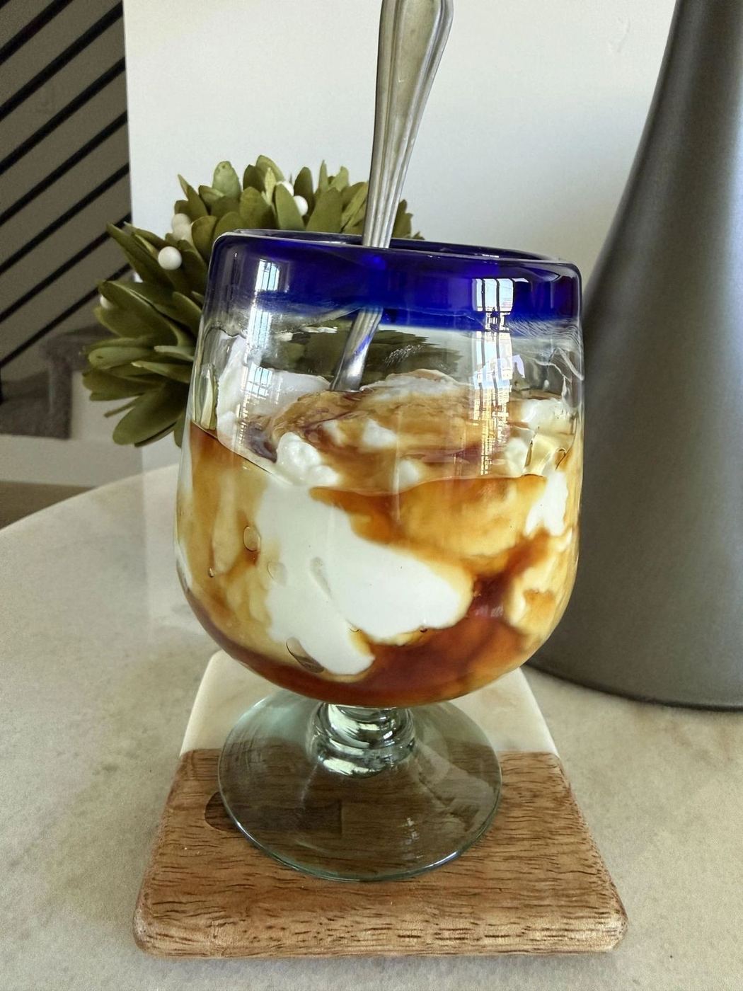 Bowl of thick Icelandic skyr layered with fresh berries on a wooden table
